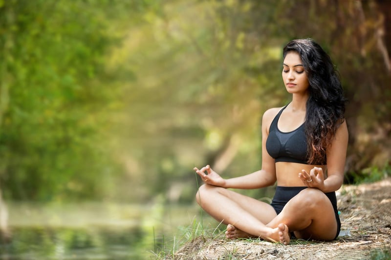 Woman doing yoga by the beach